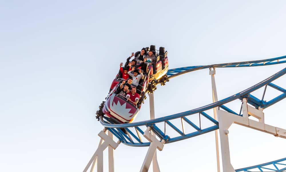 people riding roller coaster