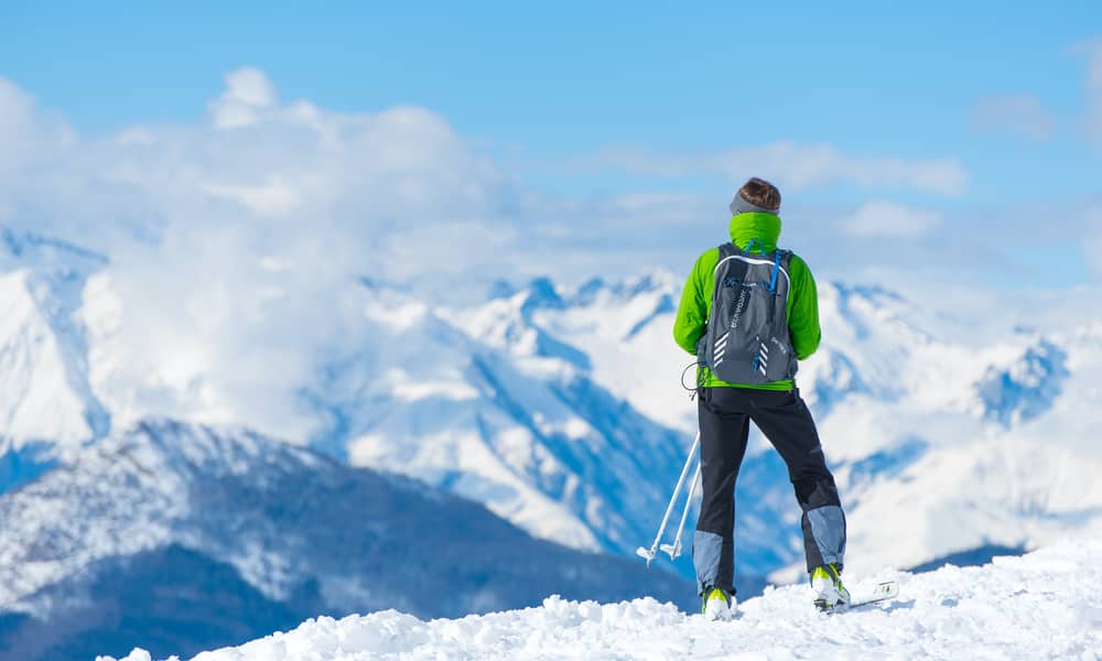 skiier standing on hill