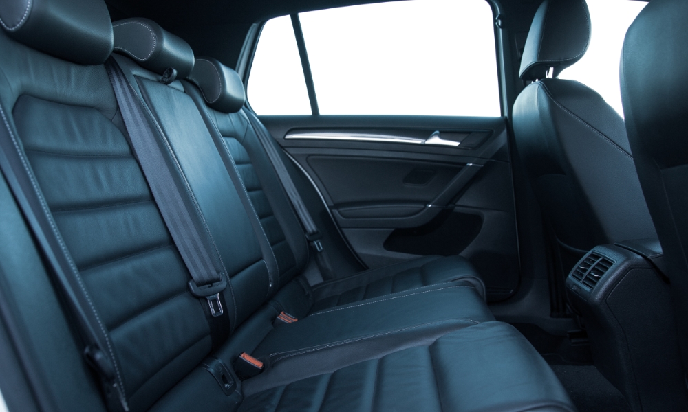 car interior rear seat showing seatbelt releases
