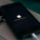 iPhone sitting on MacBook running software update