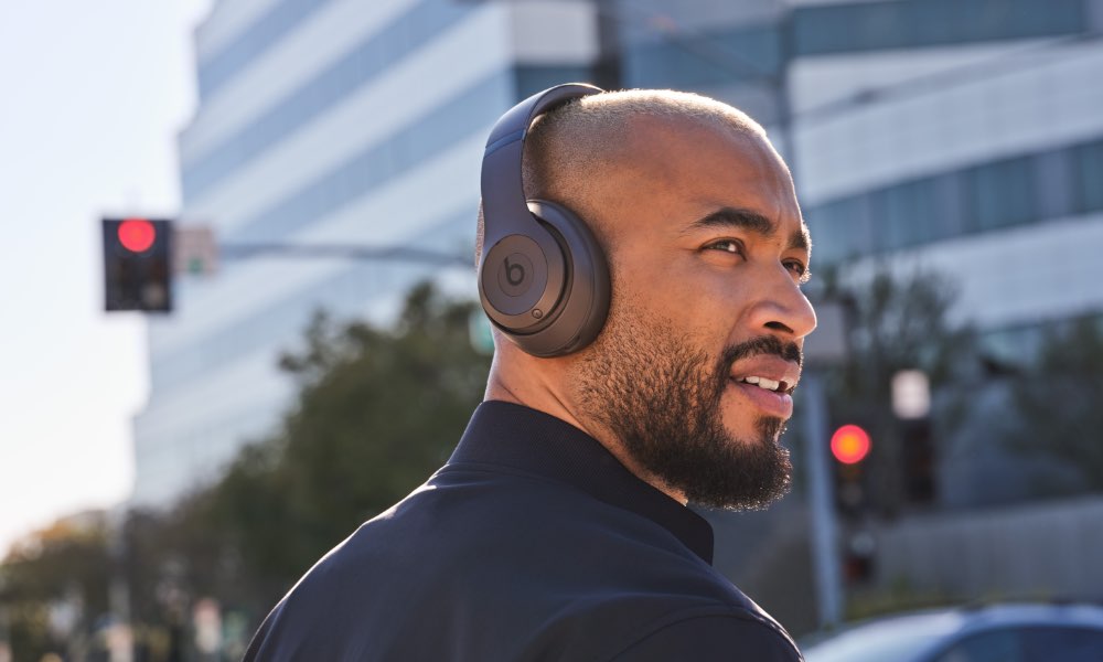 Man wearing Beats Studio Pro on street.