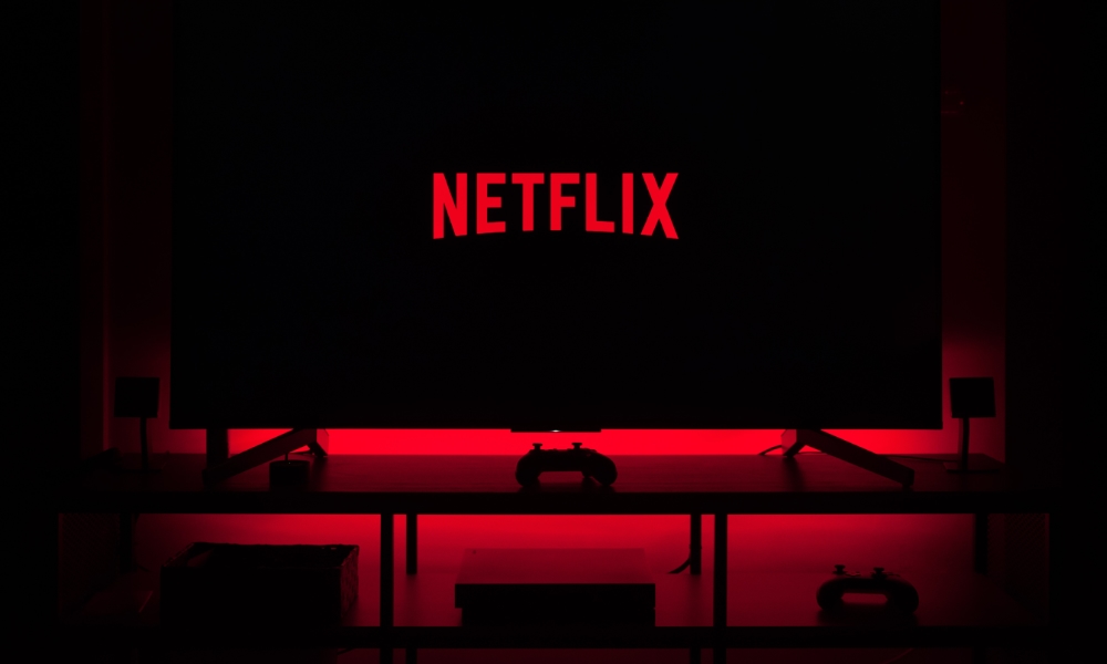 Netflix logo on TV in dark room with red backlight