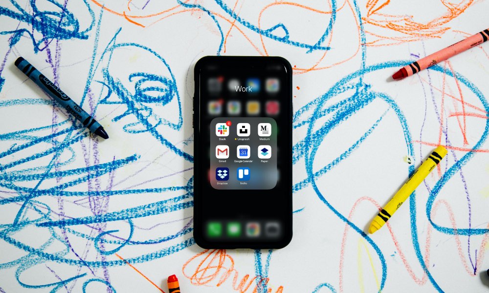 iPhone on work surface with crayons