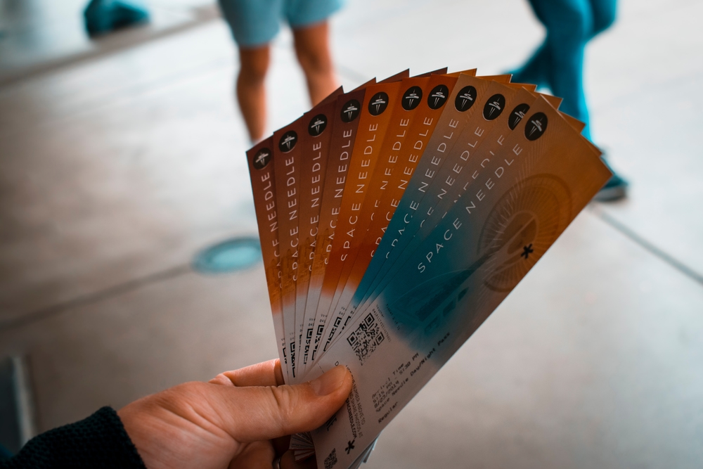 person holding faned out tickets
