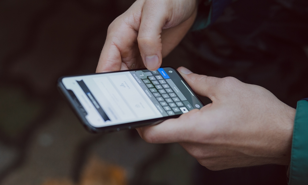 person typing on iPhone person typing on iPhone