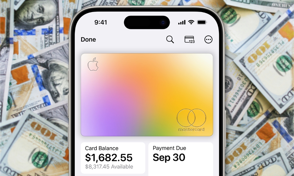 Apple Card on iPhone against cash background of hundred dollar bills