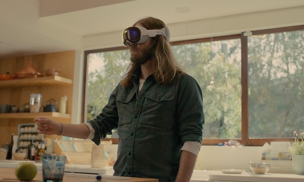 bearded man wearing Vision Pro in kitchen