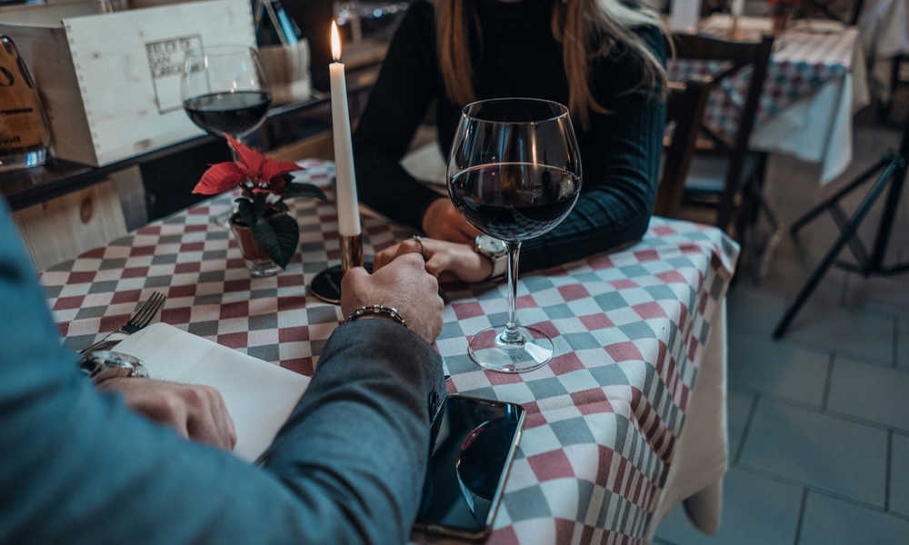 couple holding hands over romantic dinner