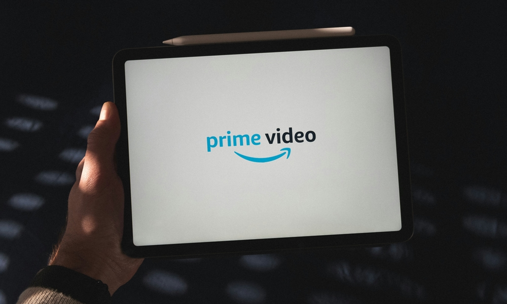 person holding iPad with Amazon Prime Video logo
