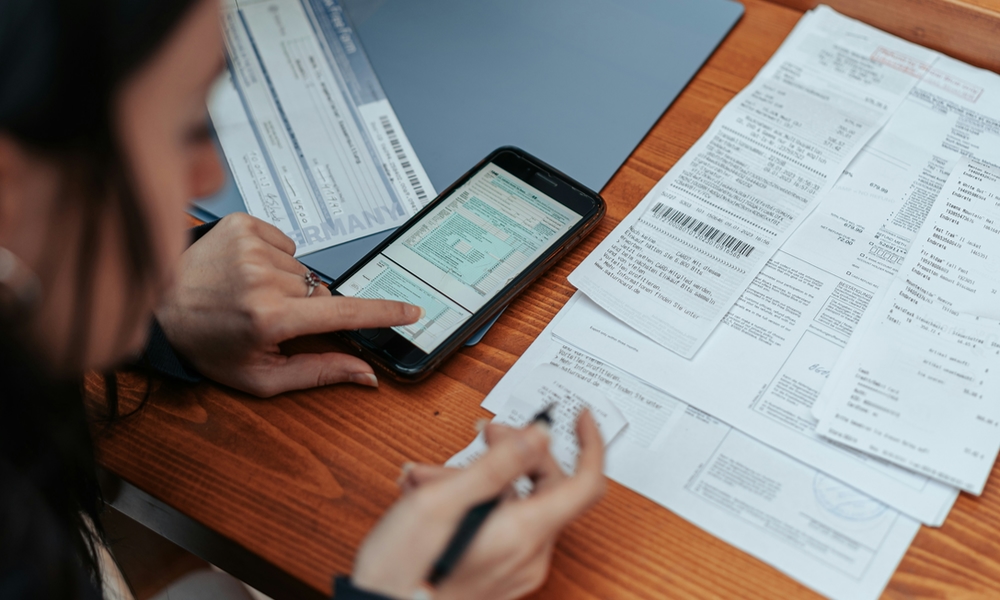 woman working on phone and taxes