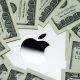 Apple company logo seen on Macbook M1 laptop surrounded by US dollar banknotes. Concept. Selective focus. United Kingdom, Stafford, December 18, 2021.