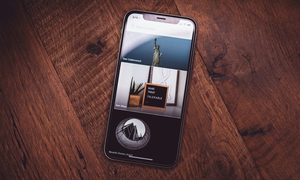 iPhone showing photos on wooden table