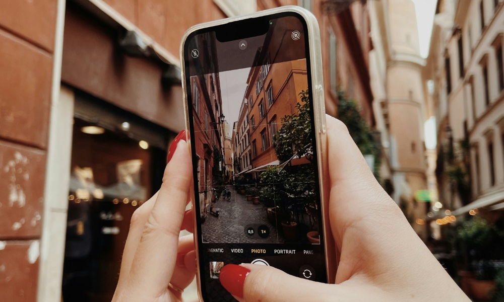person taking photo with iPhone in Rome