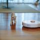 robot vacuum in living room with kittens