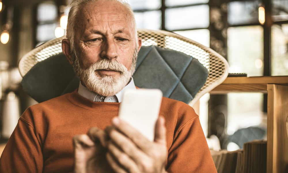 older man using smartphone