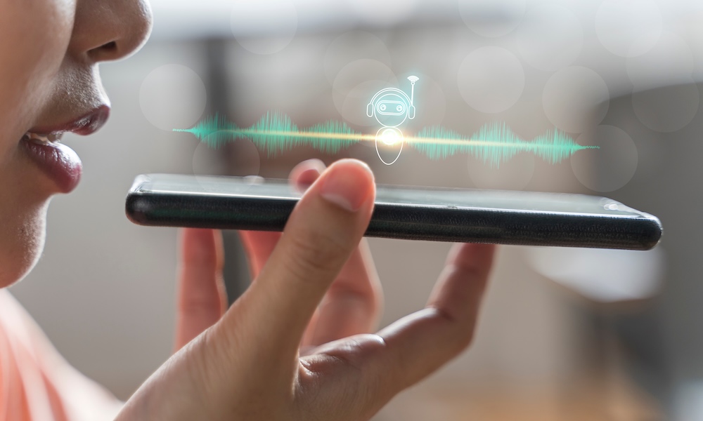 Close up of pretty woman holding in hand smart phone talking with digital assistant or friend distantly uses easy voice messaging, concept of modern ai technology