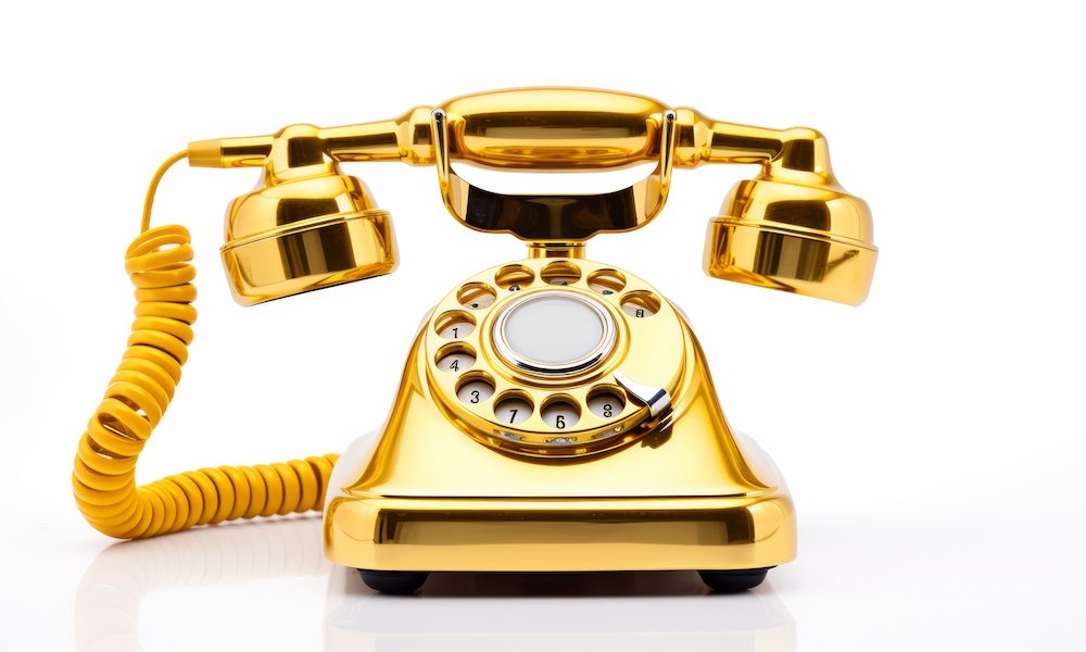 Gold vintage styled rotary phone isolated in white background. Neural network ai generated