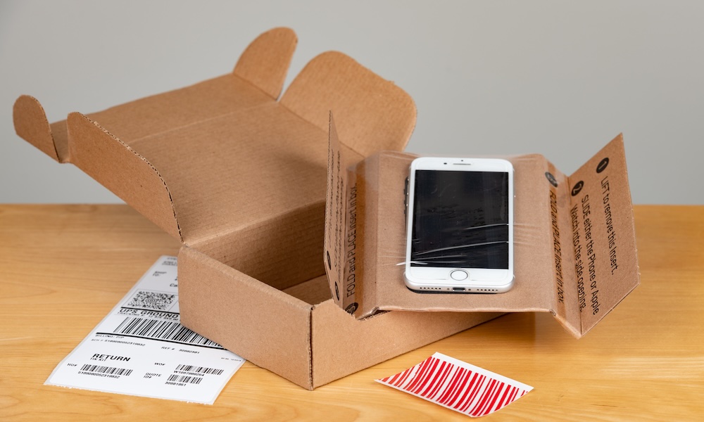 Apple iPhone trade in kit ready to be shipped with a shallow depth of field and copy space