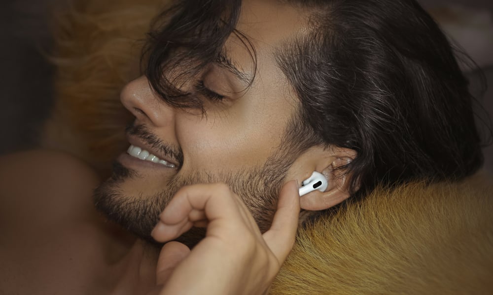 man wearing AirPods sleeping