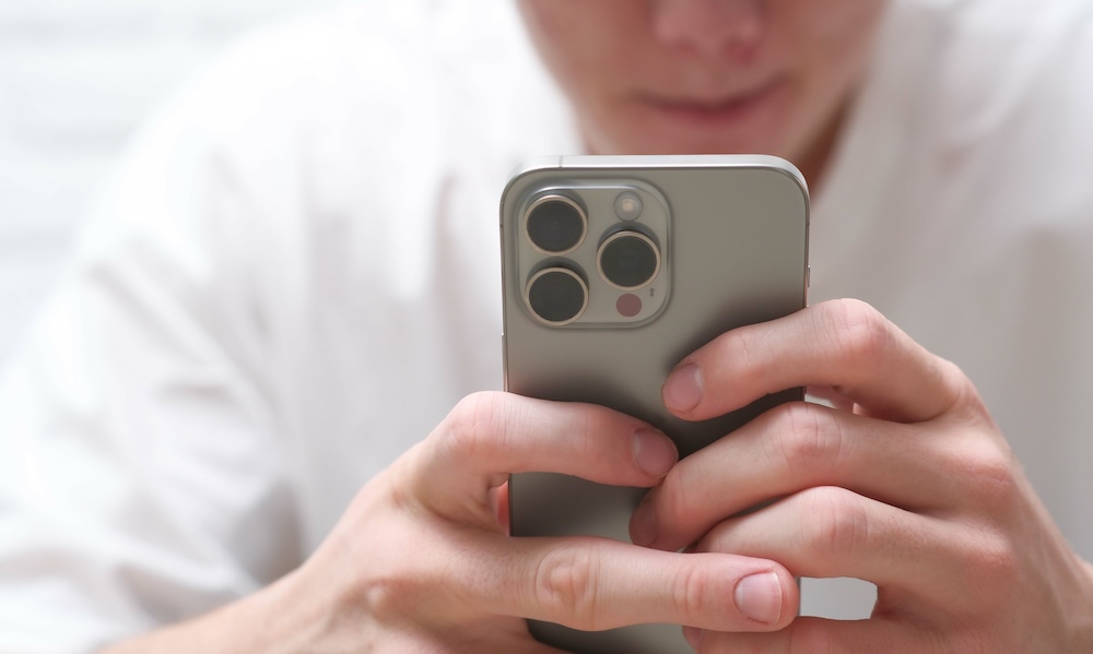 A CloseUp View of Hands Firmly Holding a Smartphone in a Contemporary Modern Setting