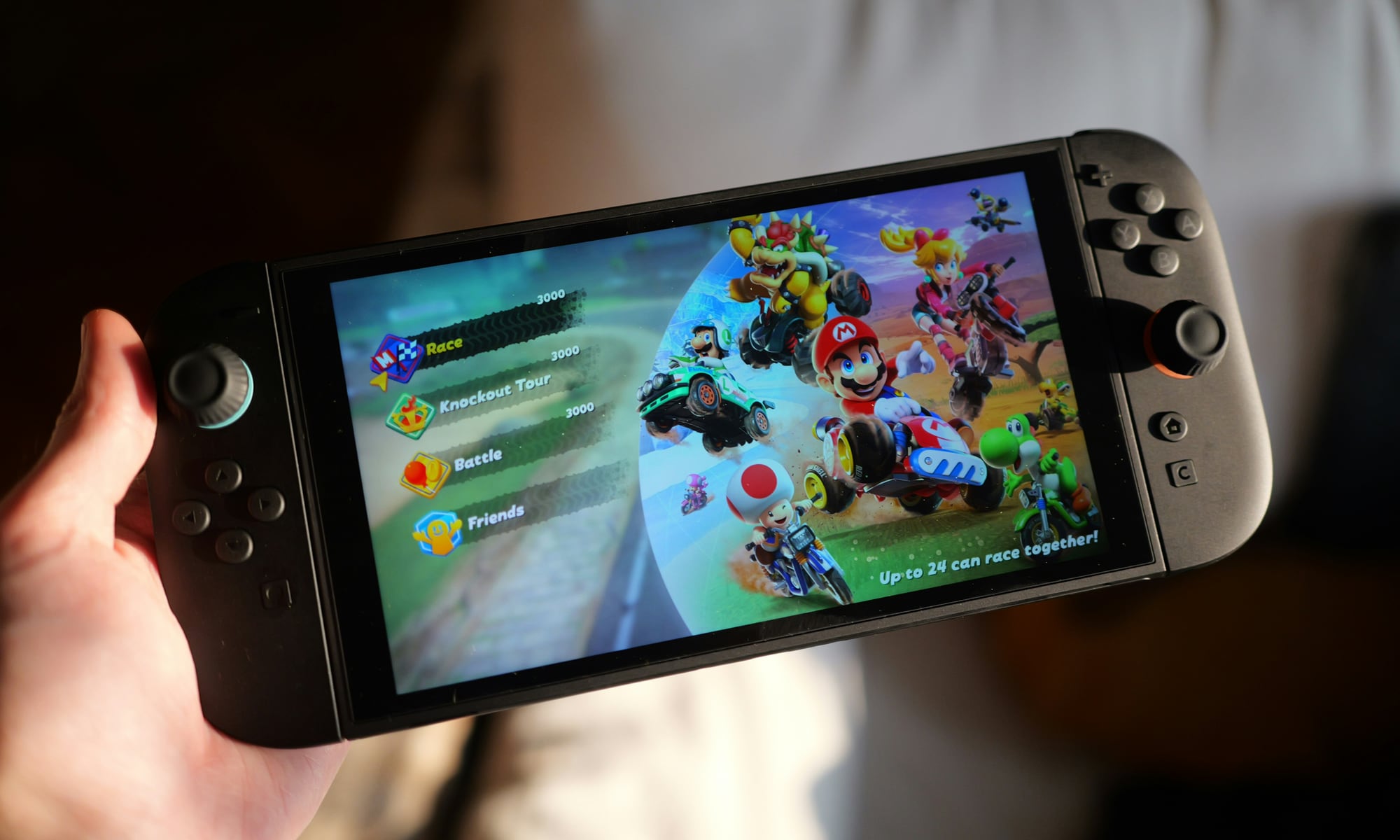 person holding Nintendo Switch 2 with Mario Kart
