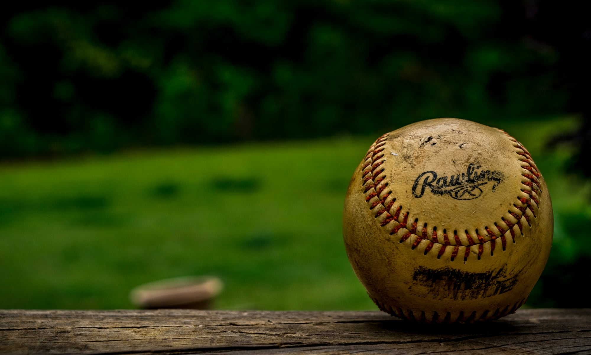 old baseball on wooden bench