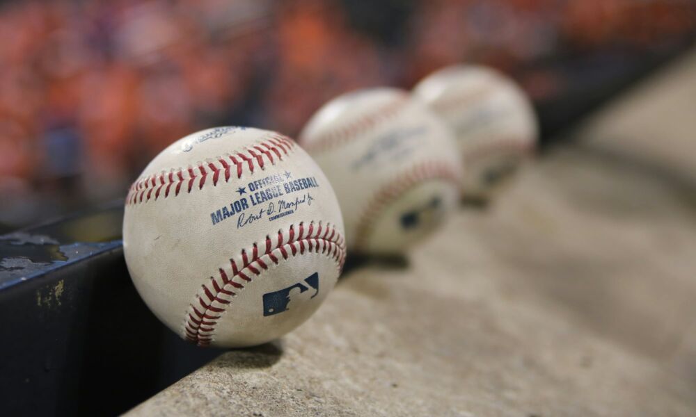 three MLB baseballs