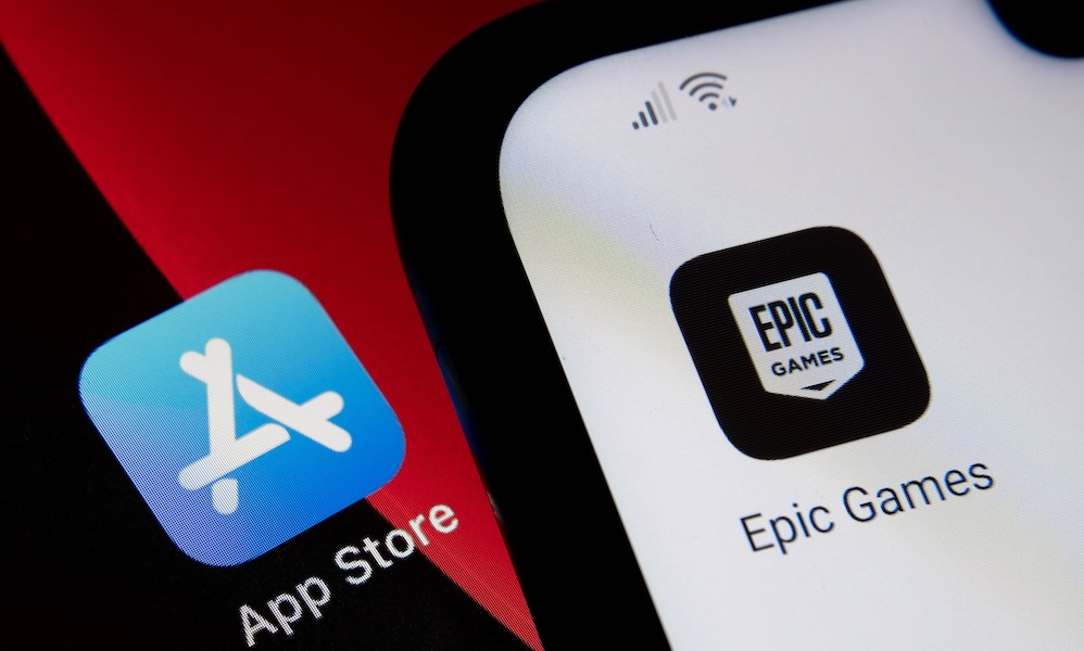 App Store vs Epic Games. Concept. App Store icon seen on ipad and Epic Games Fortnight icon seen on android phone. Selective focus. Stafford, UK, May 2, 2021.