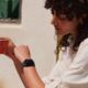 woman in cafe looking at her Apple Watch