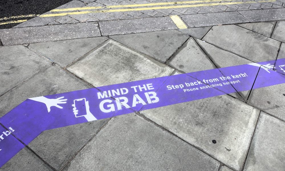 Warning sign for the 'Mind the Grab' campaign. The campaign alerts individuals to the danger posed by phone thieves on Oxford Street, Central London.