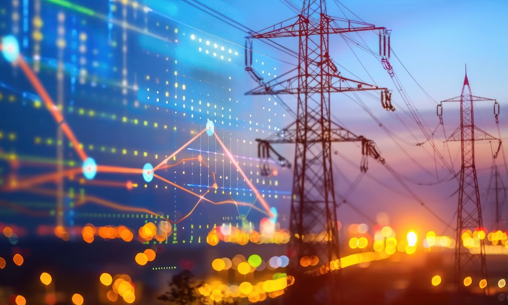 Silhouetted high-voltage electricity transmission towers against a sunset sky, with a superimposed digital graphic representing data points and network connectivity.