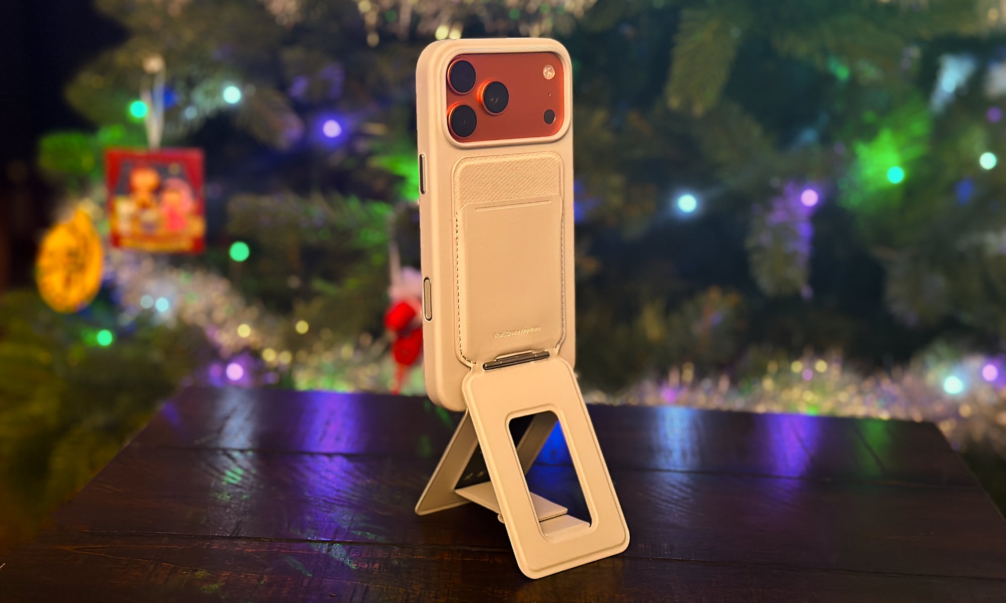 MOFT Movas Snap Case standing up with Snap Tripod Wallet with a Christmas tree in the background.