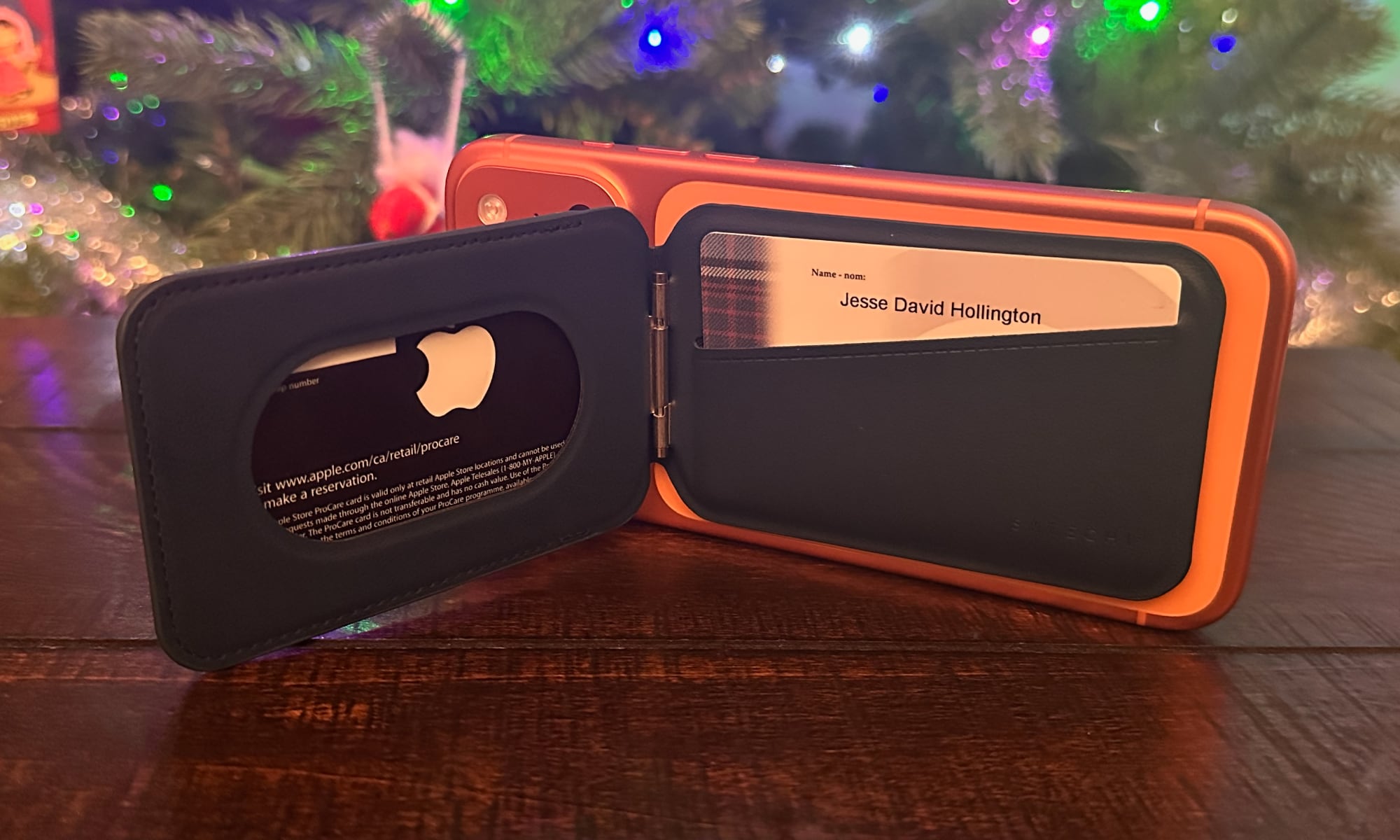 A rear view of an iPhone 17 Pro Max on its side being held up by an open 
Satechi Magnetic Wallet Case showing the interior card compartments. 