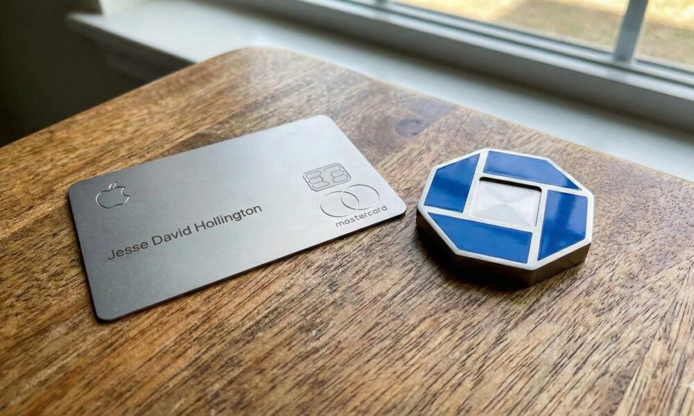 A physical titanium Apple Card on a wooden table next to a Chase bank logo.