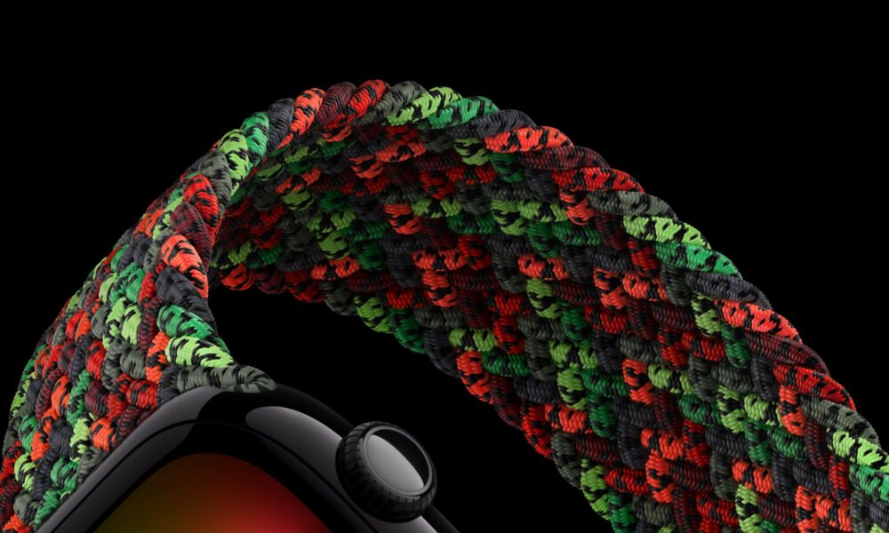Close-up of the 2026 Apple Watch Black Unity Connection Braided Solo Loop featuring a vibrant weave of red, green, and black recycled polyester yarn filaments.