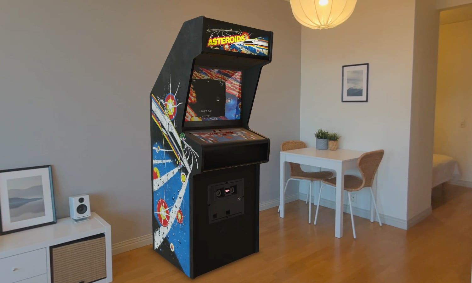A digital 3D replica of the original Asteroids arcade machine placed in a real-world setting via spatial computing. The cabinet features authentic space-themed side art and a glowing screen displaying the game's signature white vector lines on a black background, with the control panel visible in high detail.