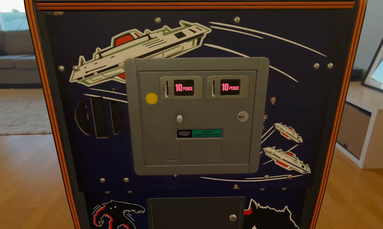 A high-resolution 3D render of a classic arcade machine's double coin door. The image highlights the "spatial furniture" detail in Retrocade, showing brushed metal textures, "25&cent;" labels, and two backlit red coin return buttons, all rendered with realistic light reflections within the Apple Vision Pro environment.