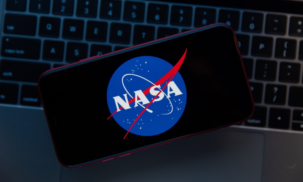 A close-up view of a smartphone screen displaying the official NASA "meatball" logo against a dark background.