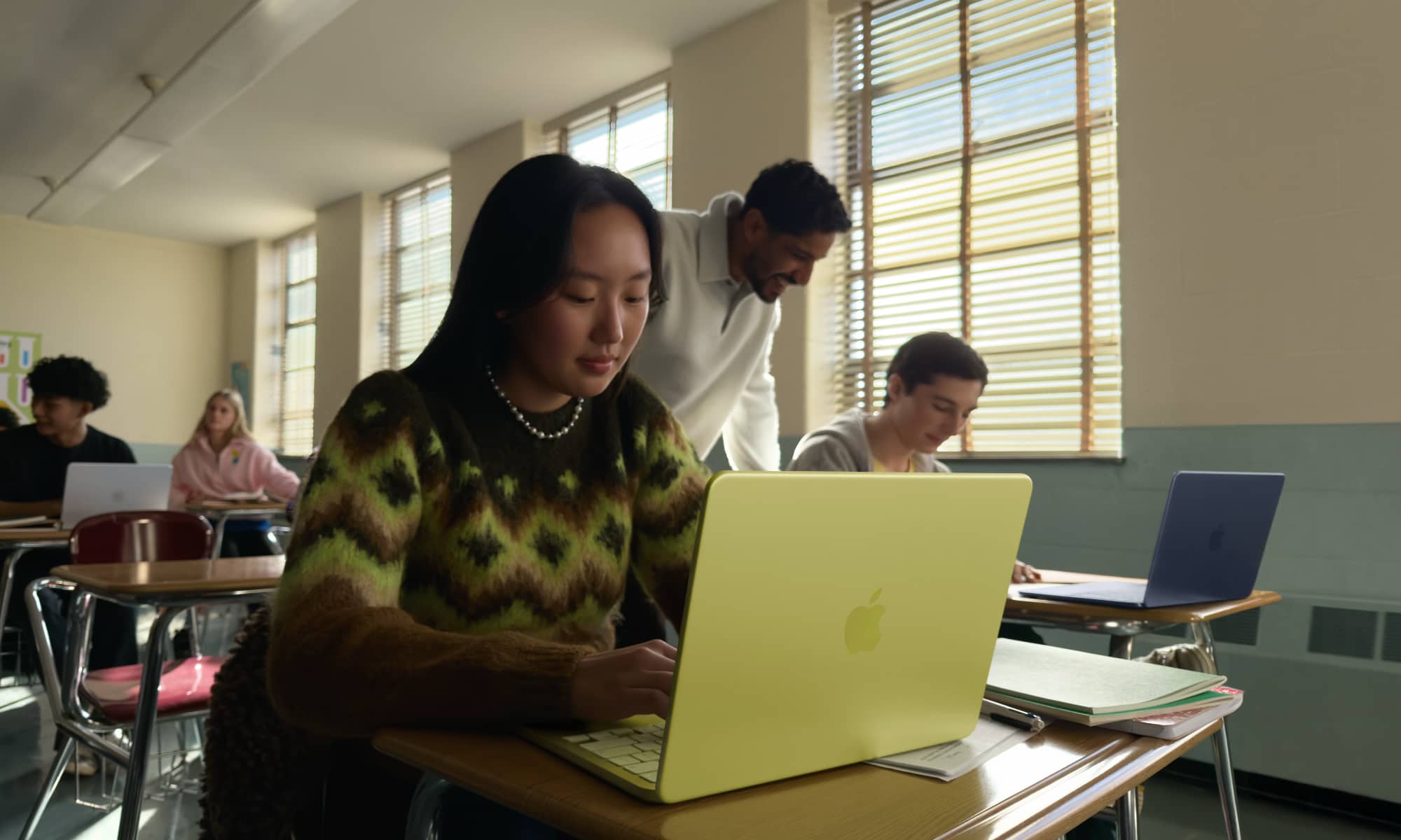 Student working in a classroom on a Citrus MacBook Neo.