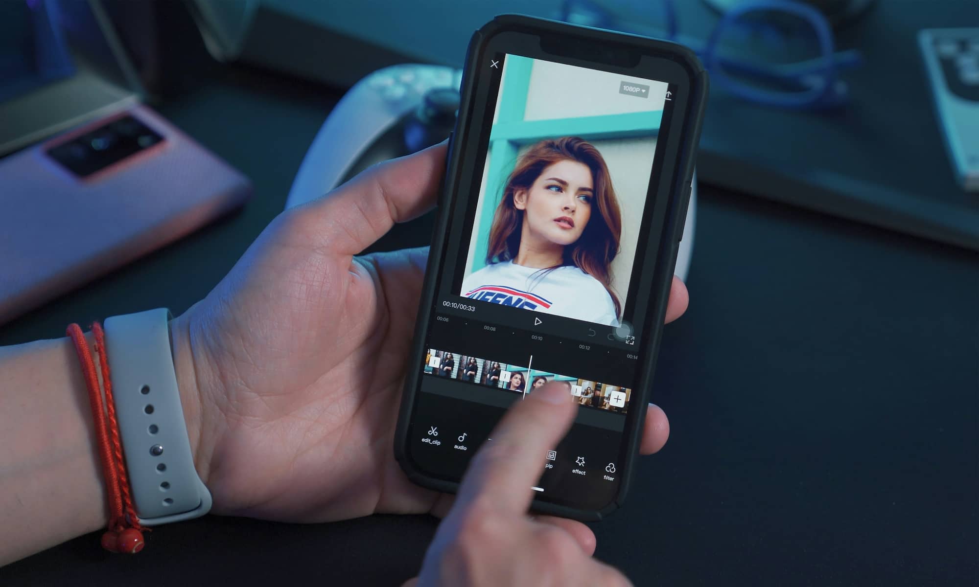 A person holding an iPhone while editing a video with CapCut.