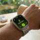 A photorealistic close-up of an Apple Watch Ultra 3 showing an exact watchOS 26.4 Workout app 