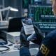A focused photograph from an over-the-shoulder perspective of an FBI forensic specialist in 2026, wearing an official patch and nitrile gloves. They are holding a modern iPhone in a dimly lit tech lab. The iPhone screen is the central focus, displaying multiple notifications with message previews that reveal private Signal conversations. The background is a detailed, slightly blurred lab environment with diagnostic equipment and computer monitors showing data analysis.