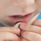 close up coin battery in the child's hands danger of swallowing
