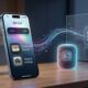 A conceptual image of an iPhone running iOS 27, showing a dark-mode Siri 'Ask' bar with a colorful waveform, alongside icons for custom Wallet passes and camera settings. Glowing data streams connect the iPhone to a stylized speaker and screen, representing native Google Cast support.