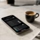 A modern iPhone 17 Pro displaying the Privacy & Security settings menu lies on a light marble coffee table next to a double espresso.