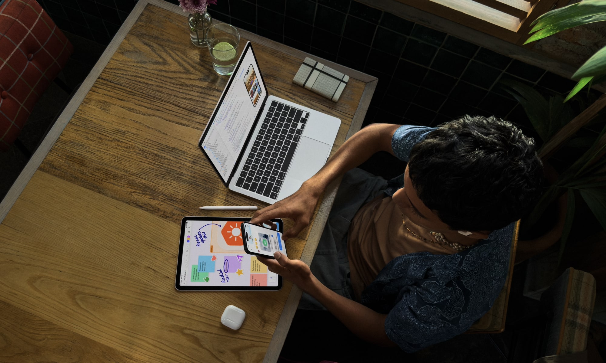 WWDC26 223 lifestyle overhead shot student desk iPhone iPad MacBook AirPods Apple Pencil