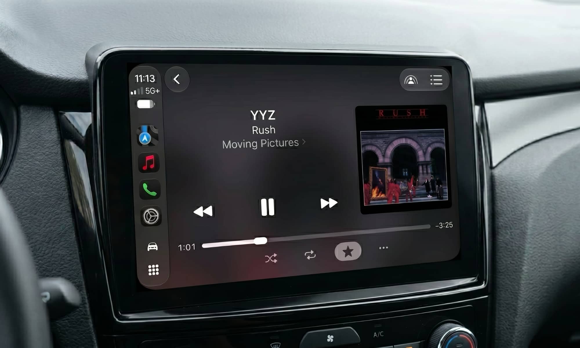 Vehicle infotainment display showing CarPlay Now Playing screen in iOS 27 with adjustable scrubber handle.