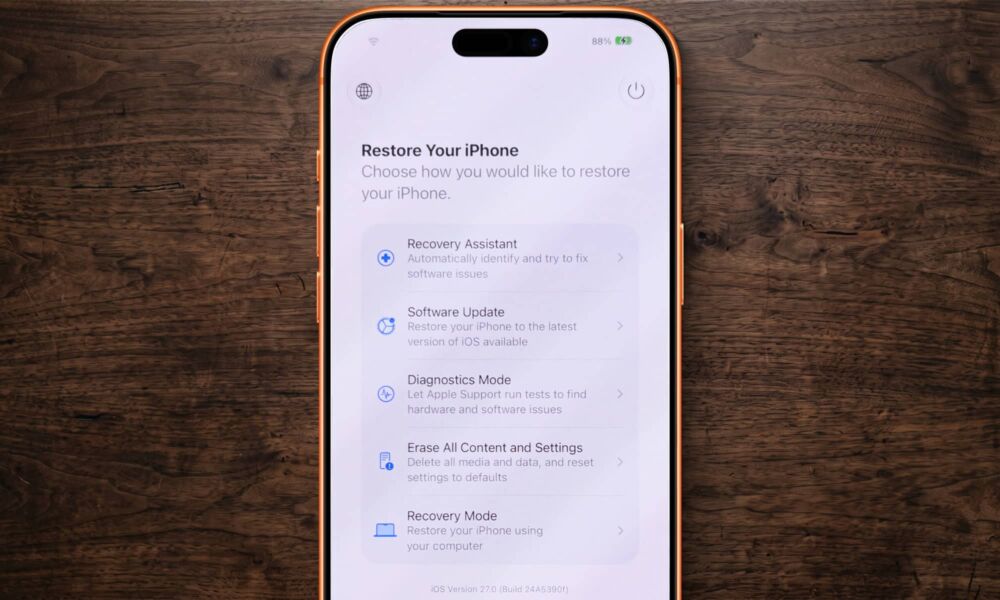 iPhone 17 Pro Max laying on a wooden desk showing the new iOS 27 Recovery Screen.