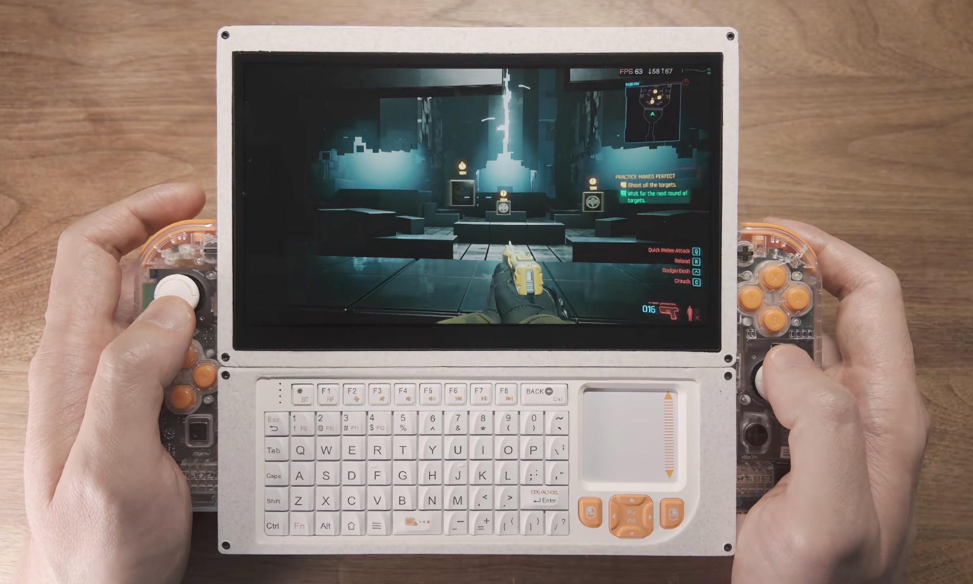 A person holding a bulky, custom-built portable Mac mini cyberdeck featuring a built-in display and attached Nintendo Joy-Con controllers.