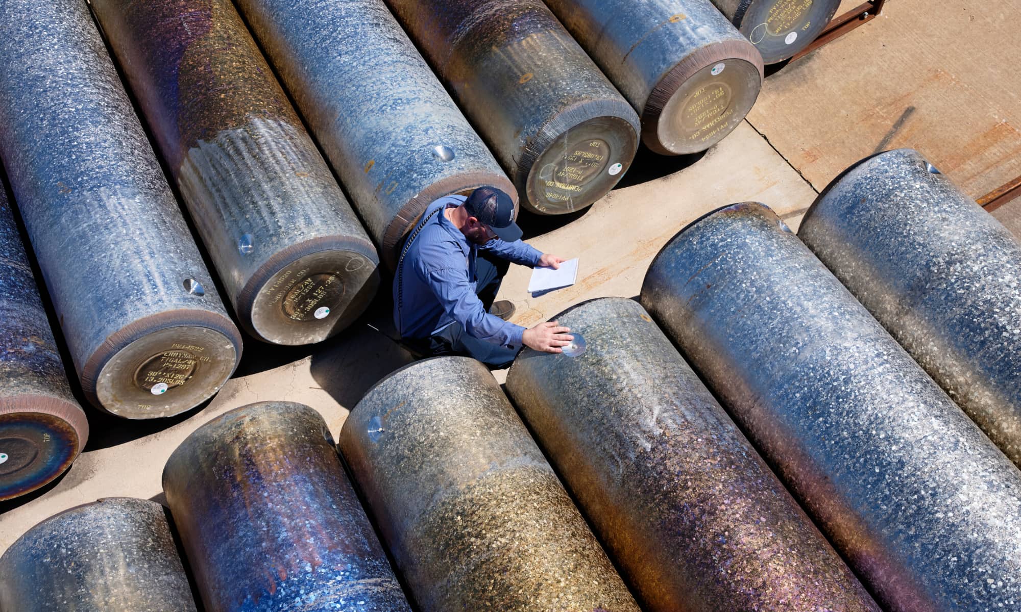 Apple American Manufacturing Program employee taking inventory of titanium stock